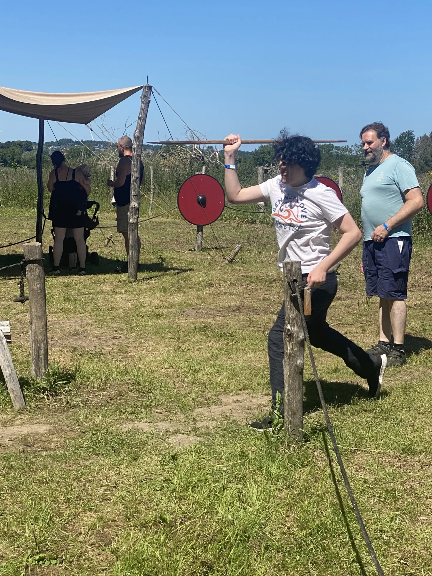 Boy throwing Viking spears into a target